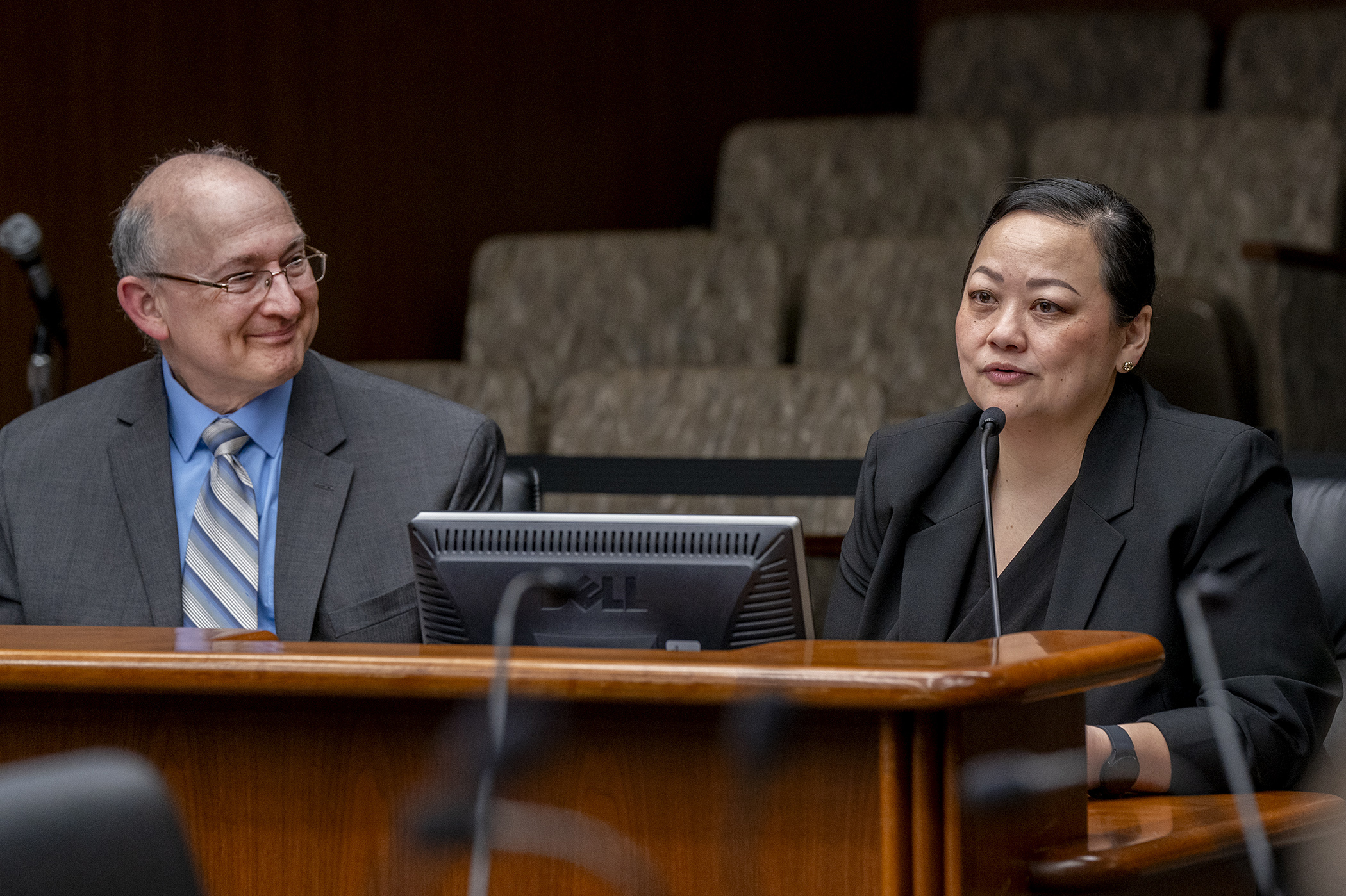 Pahoua Yang, vice president of community health and wellness at the Wilder Foundation, testifies before the House Human Services Policy Committee regarding HF3495, sponsored by Rep. Peter Fischer, left. (Photo by Michele Jokinen)